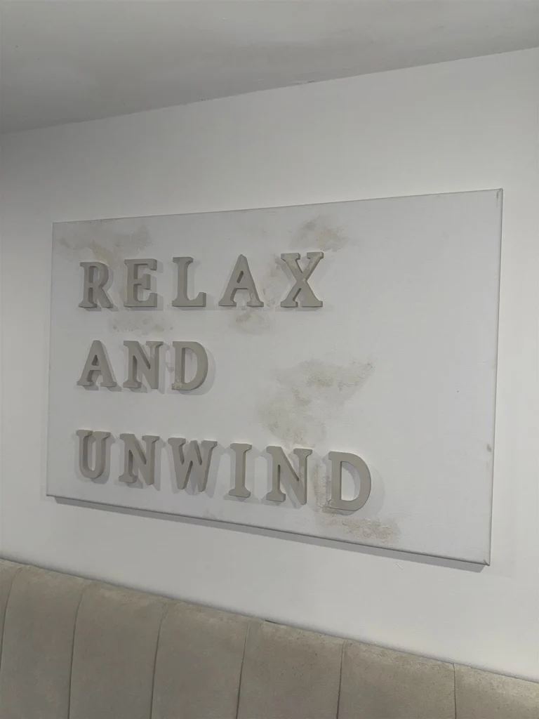 Relax and Unwind canvas hanging on a wall